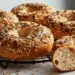 Simple Everything Bagel Recipe - Thefoodiebunch Golden Everything Bagels With Sesame Poppy Seeds And Coarse Salt On A Black Wire Cooling Rack