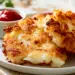 How To Make The Perfect Hash Brown Potato Recipe At Home - Thefoodiebunch Golden Crispy Hash Brown Patties On A White Plate With One Broken Open Showing Fluffy Interior